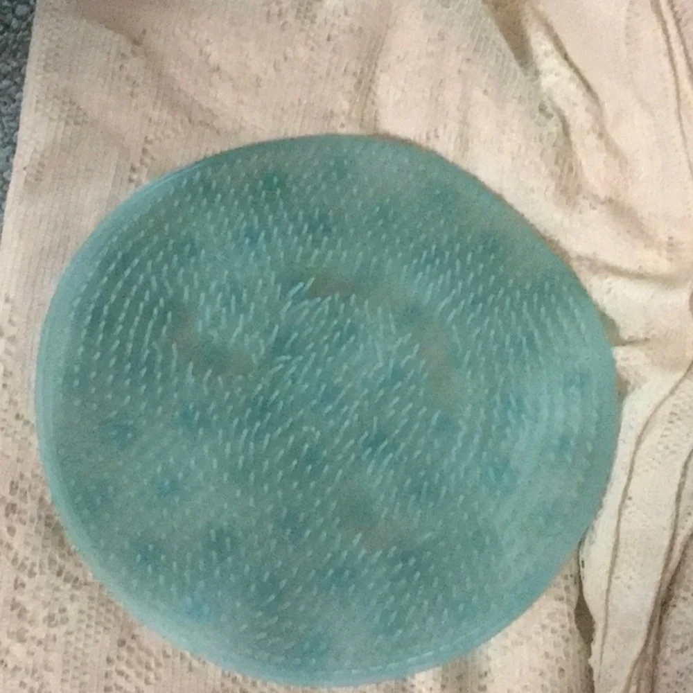 Aqua blue small round shower mat.